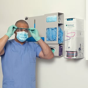 TIDIShield Grab 'n Go protective eyewear dispenser in use by male nurse 