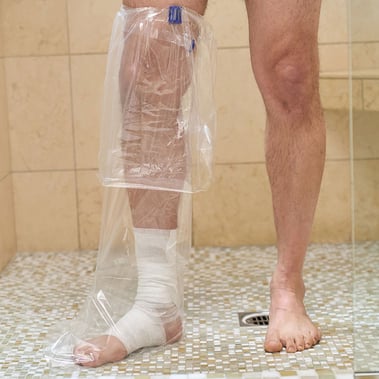 aquaguard boot in use on homecare patient in a shower with water seal band