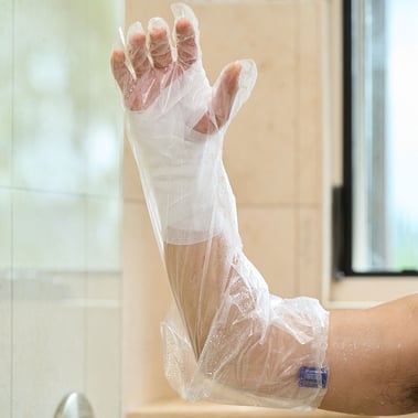 aquaguard glove in use on homecare patient in shower with a water seal band