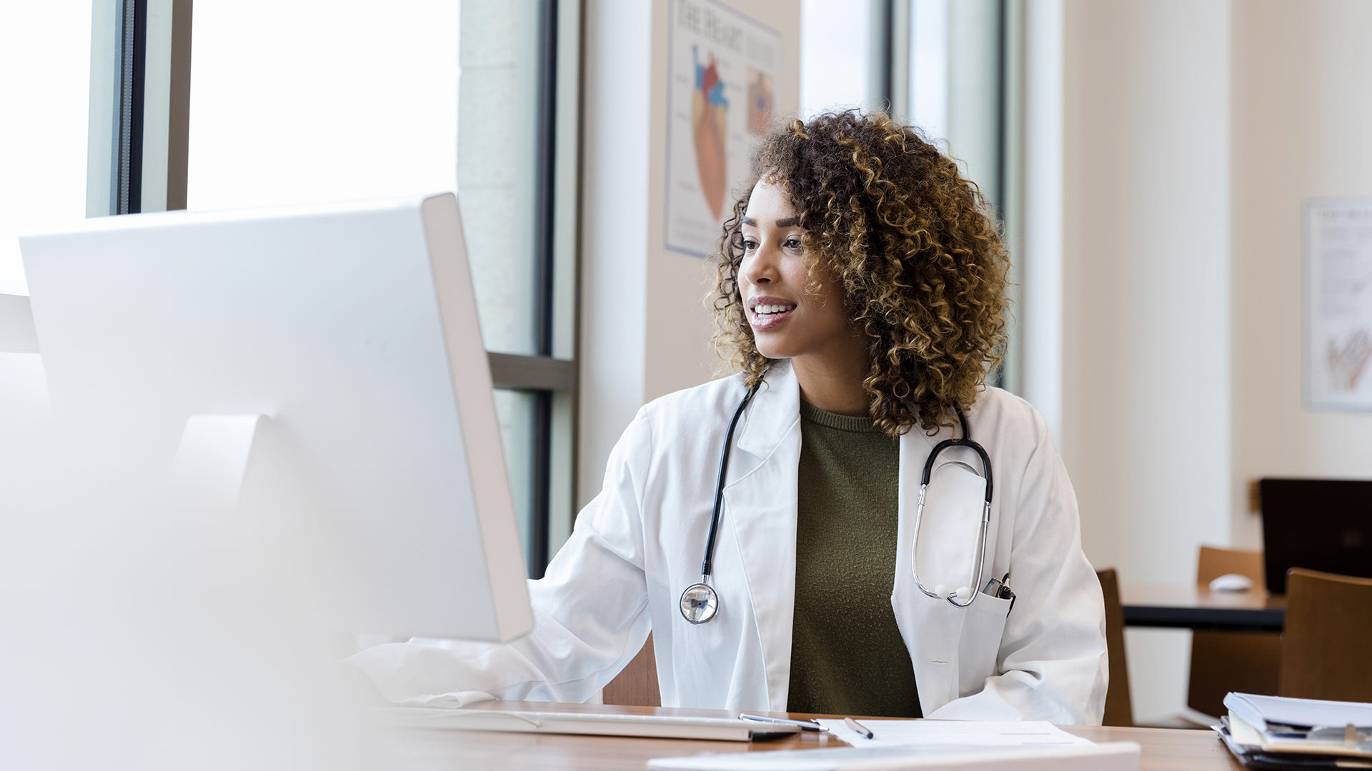 female_in_labcoat_in_front_of_computer