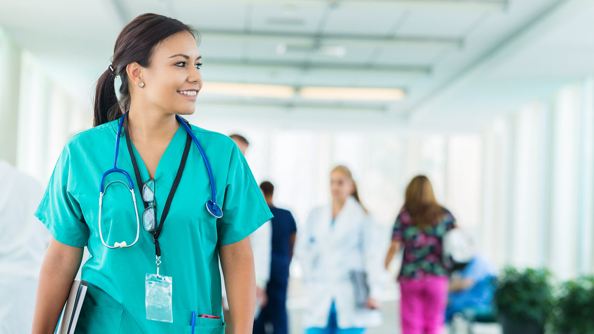 female_in_scrubs_walking_down_hall