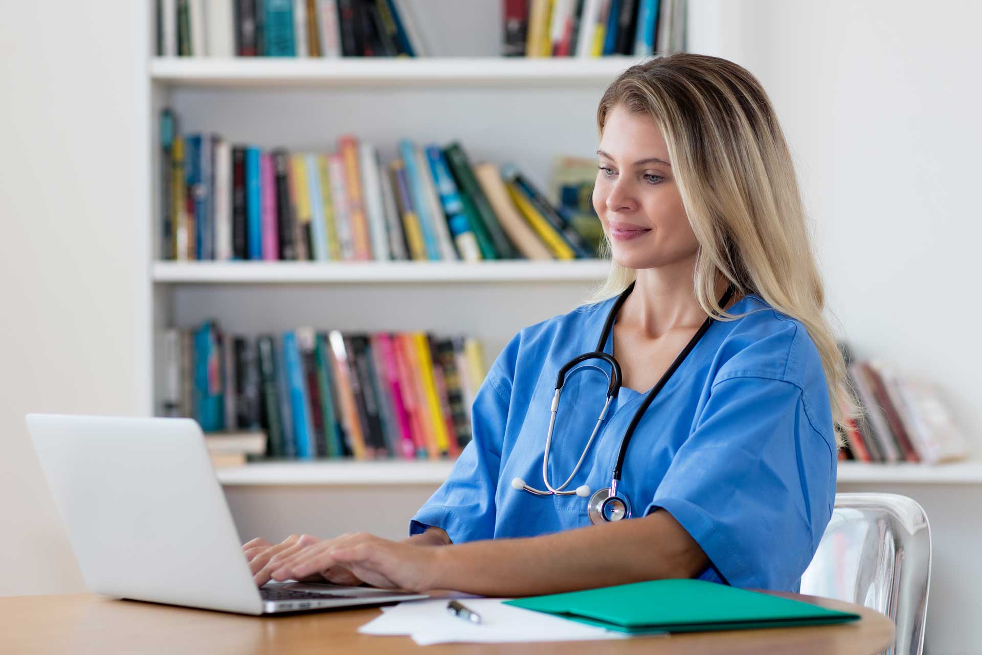 nurse_working_at_laptop_smiling